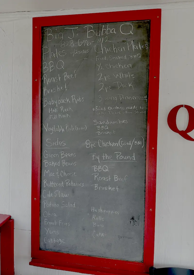 Chalkboard menu at Big J’s Bubba-Q in Arden North Carolina featuring brisket, baby back ribs, fried chicken, and southern sides like mac and cheese and baked beans.